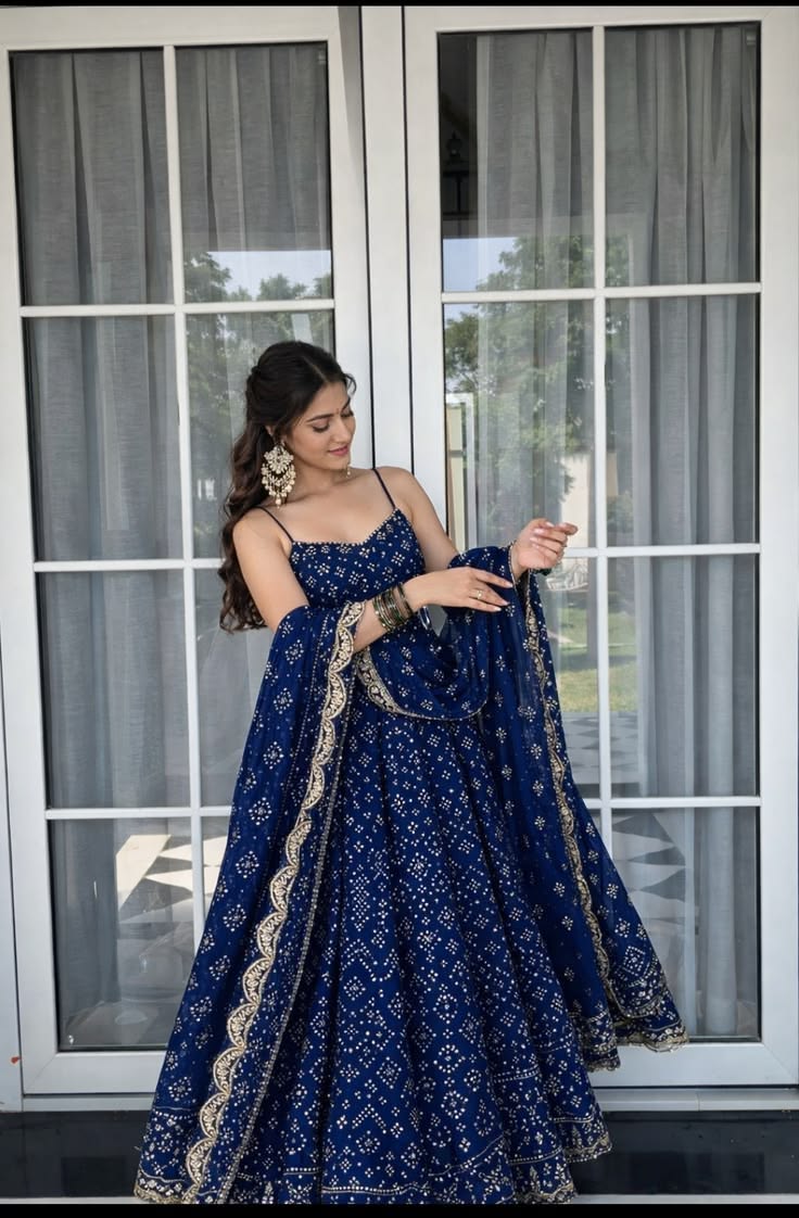 Woman wearing a navy blue embellished lehenga